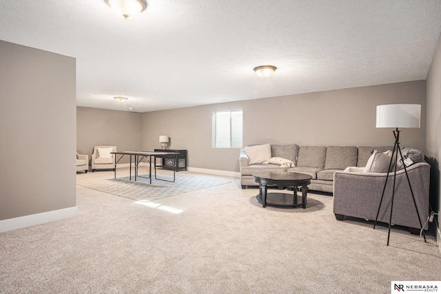 living room featuring carpet and a textured ceiling