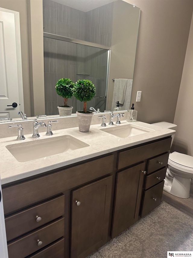 bathroom featuring vanity, hardwood / wood-style flooring, and toilet