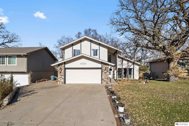 view of front of property featuring a garage and a front lawn