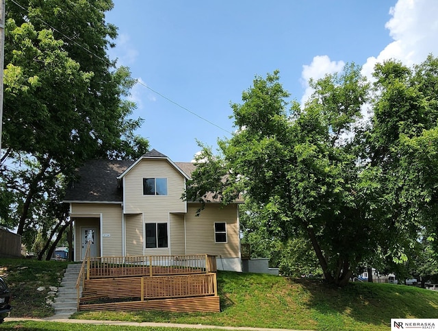 back of property featuring a yard