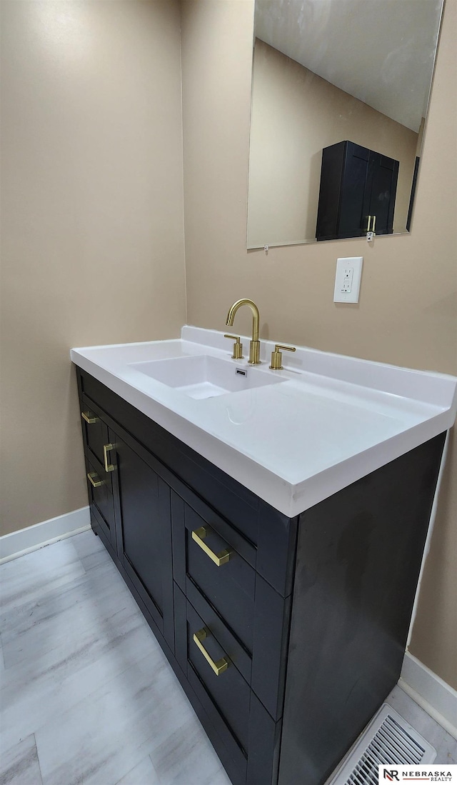 bathroom with hardwood / wood-style floors and vanity