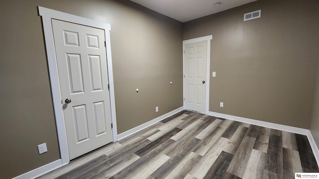 unfurnished room featuring hardwood / wood-style flooring