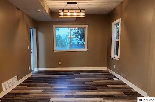 unfurnished dining area with dark hardwood / wood-style floors