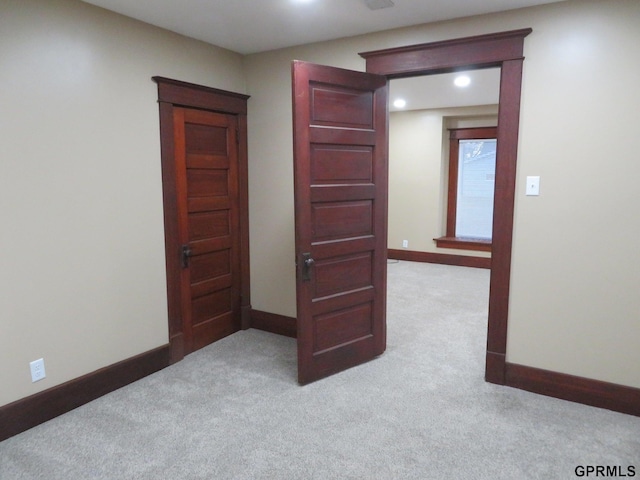 unfurnished bedroom featuring light colored carpet