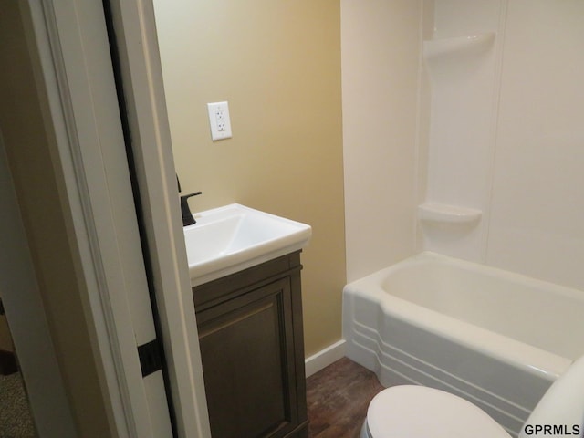 bathroom featuring vanity, hardwood / wood-style flooring, and toilet