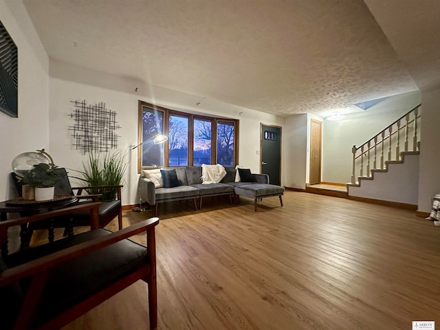 living room featuring a textured ceiling and hardwood / wood-style flooring