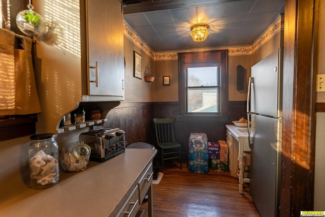 706 1st Ave, Nebraska City, NE 68410 - kitchen with a wainscoted wall, freestanding refrigerator, dark wood-type flooring, and wood walls