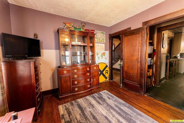 706 1st Ave, Nebraska City, NE 68410 - bedroom with dark wood-type flooring, a textured ceiling, and baseboards