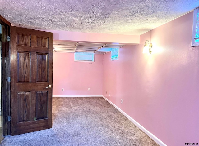 basement with carpet floors and a textured ceiling