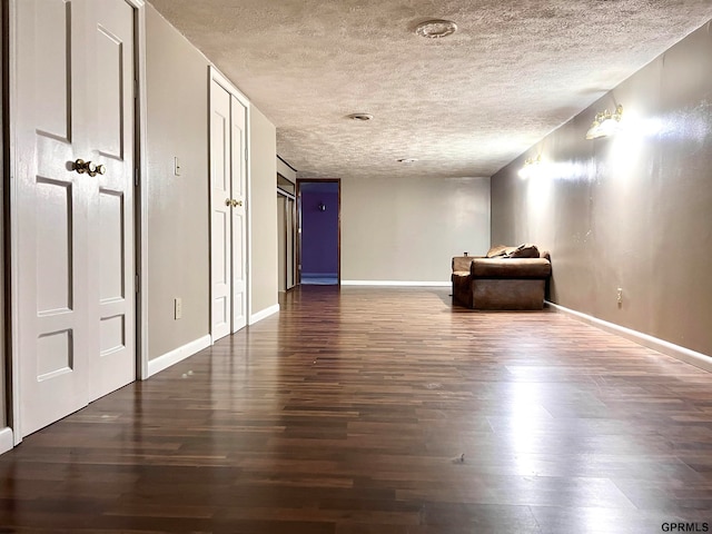 unfurnished bedroom featuring dark hardwood / wood-style flooring and a textured ceiling