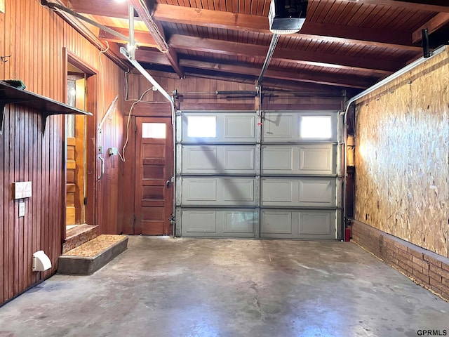 garage with wood walls, wood ceiling, and a garage door opener