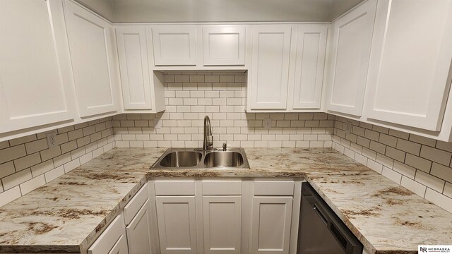 kitchen with white cabinets, stainless steel dishwasher, and sink