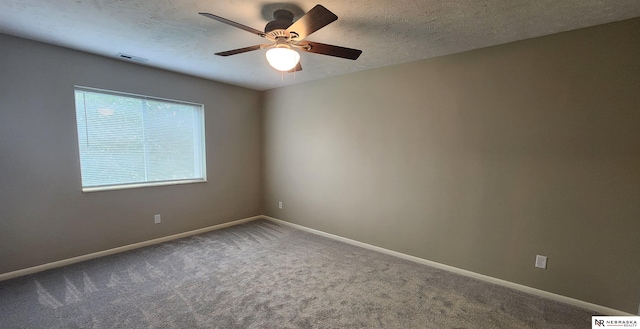 spare room featuring ceiling fan, carpet floors, and a textured ceiling