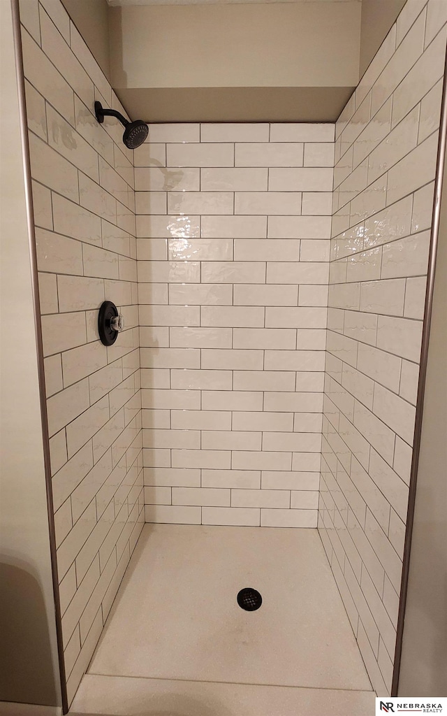 bathroom with tiled shower