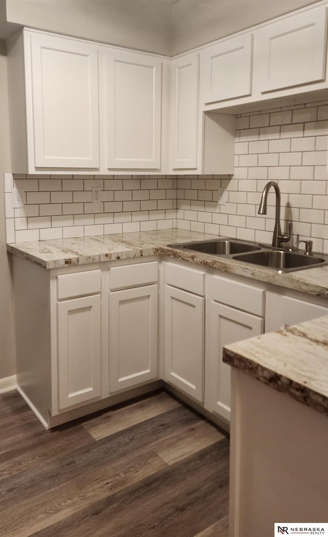 kitchen with white cabinets, decorative backsplash, dark hardwood / wood-style flooring, and sink