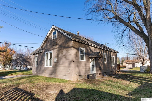 view of side of home with a lawn