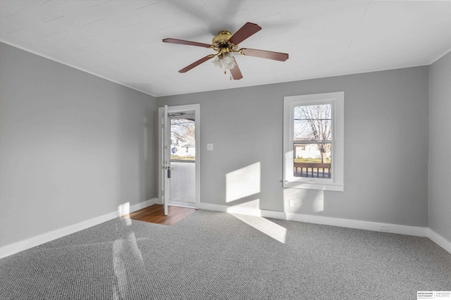 spare room with ceiling fan and carpet