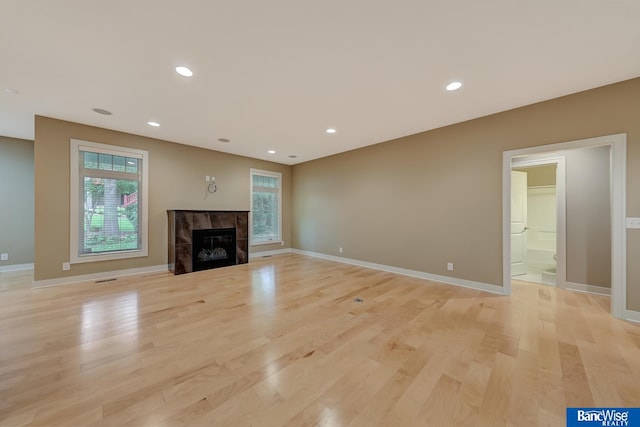 unfurnished living room with light hardwood / wood-style floors and a fireplace