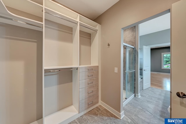 walk in closet with light wood-type flooring