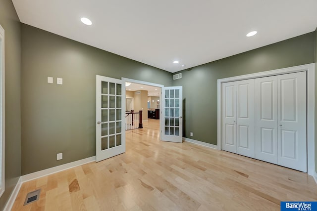 interior space featuring french doors and light hardwood / wood-style floors