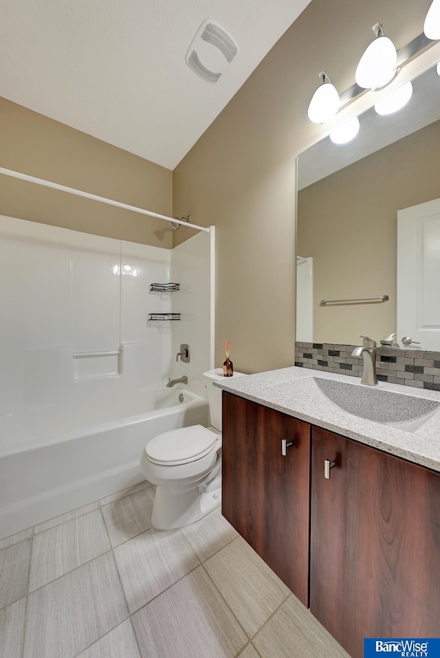 full bathroom with tasteful backsplash, tile patterned floors, toilet, vanity, and shower / bathtub combination