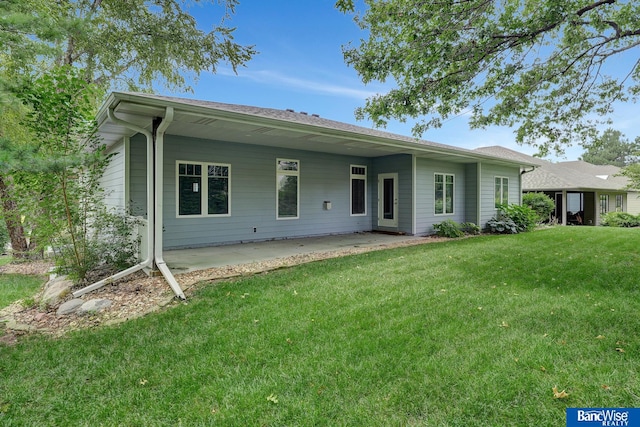 back of property featuring a lawn and a patio area