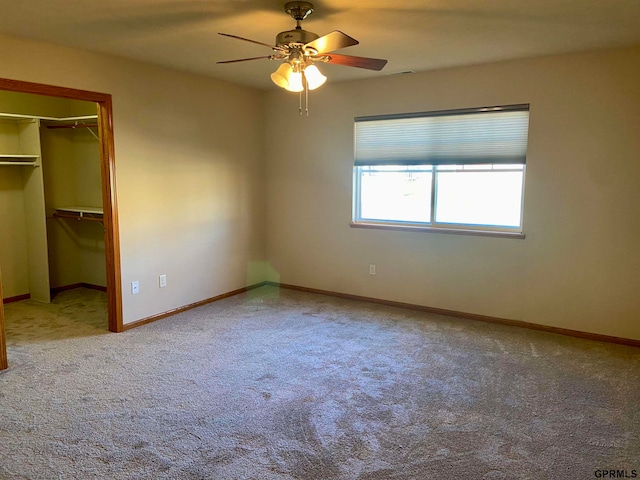 unfurnished bedroom with ceiling fan, carpet floors, and a closet