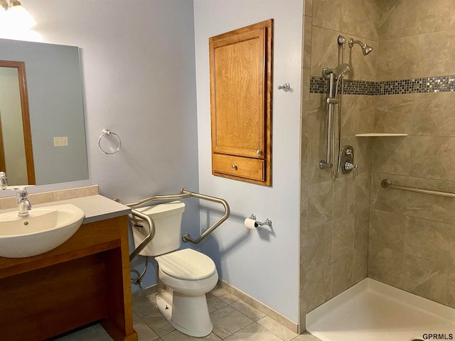 bathroom with tile patterned floors, vanity, toilet, and a tile shower