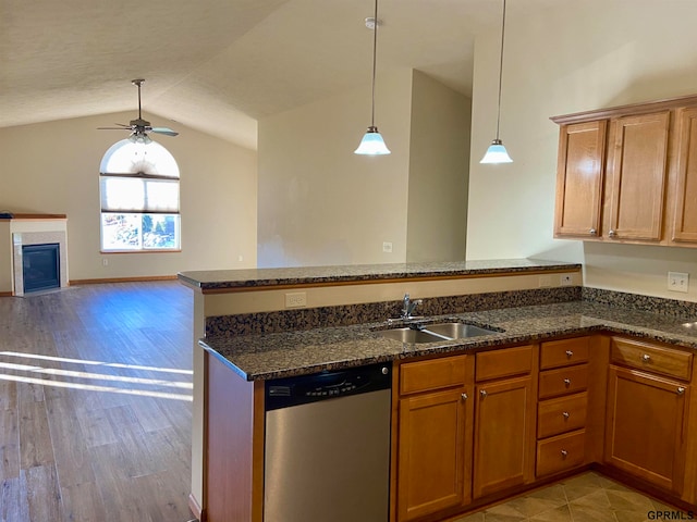 kitchen with sink, hanging light fixtures, stainless steel dishwasher, ceiling fan, and light hardwood / wood-style floors