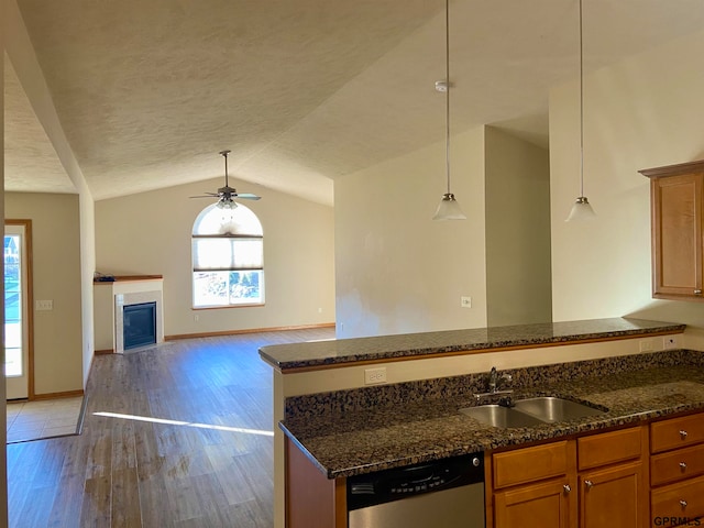 kitchen featuring sink, pendant lighting, dishwasher, hardwood / wood-style floors, and lofted ceiling