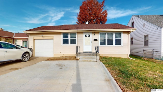 view of front of property featuring a front lawn and a garage