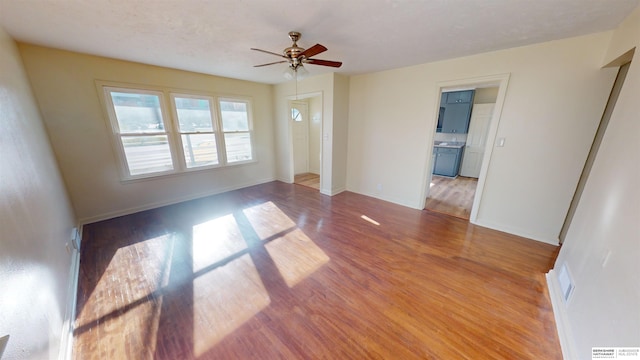 spare room featuring ceiling fan and light hardwood / wood-style flooring