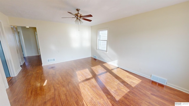 empty room featuring hardwood / wood-style floors and ceiling fan