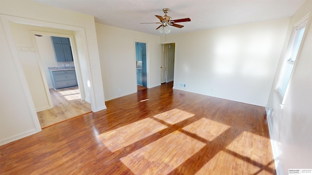 spare room with ceiling fan and wood-type flooring