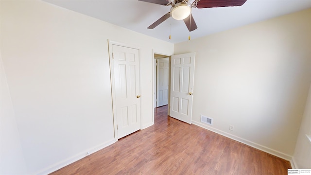 unfurnished bedroom featuring hardwood / wood-style floors and ceiling fan