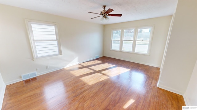 spare room featuring ceiling fan and light hardwood / wood-style flooring