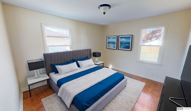 bedroom featuring dark wood-type flooring and multiple windows