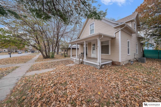 view of side of home featuring covered porch and central air condition unit