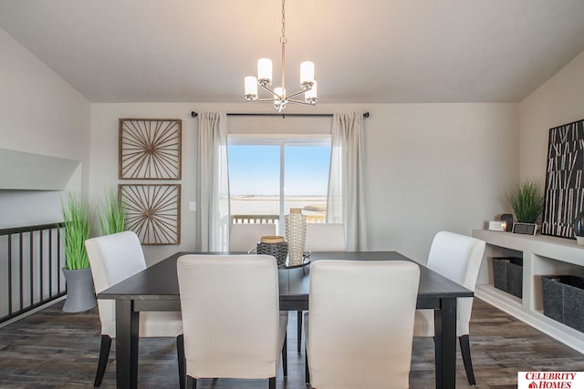 dining space with a water view, dark wood-type flooring, and an inviting chandelier