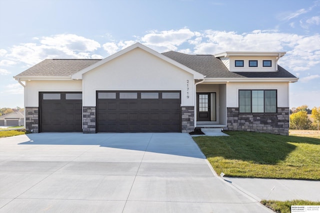 view of front of home featuring a garage and a front yard