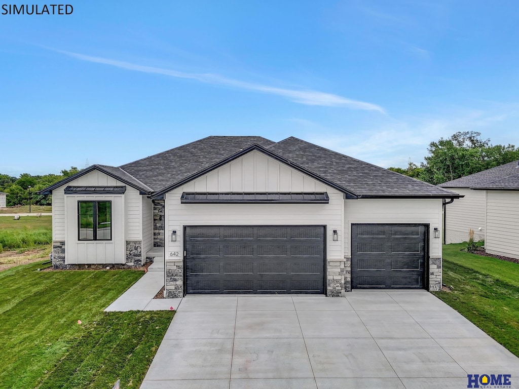 view of front of home featuring a garage and a front lawn