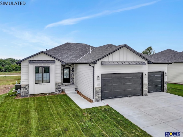 view of front of home with a front yard and a garage