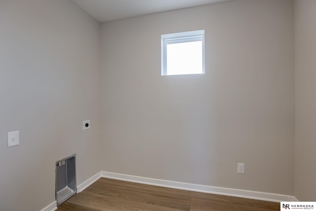 washroom with dark hardwood / wood-style flooring and hookup for an electric dryer