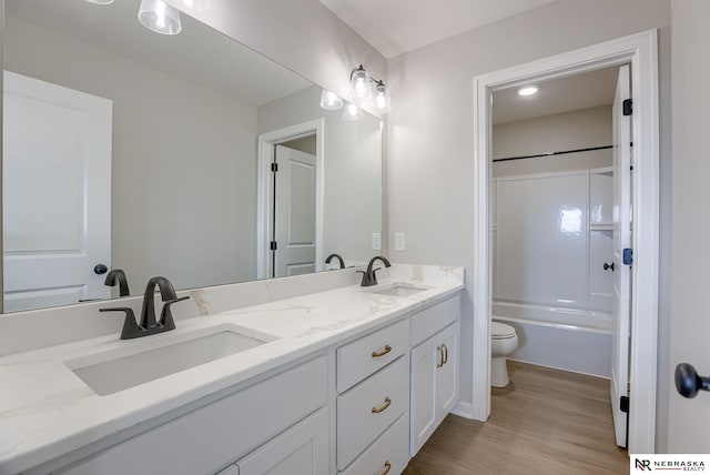 full bathroom with vanity, shower / bathtub combination, toilet, and wood-type flooring