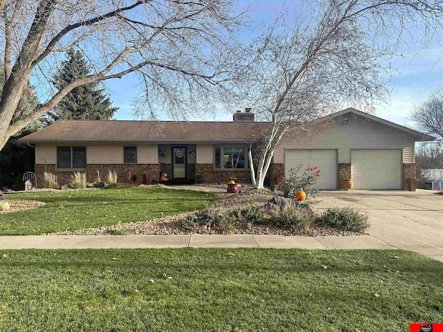 ranch-style home with a garage and a front lawn