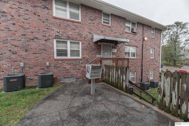 back of house with central AC unit