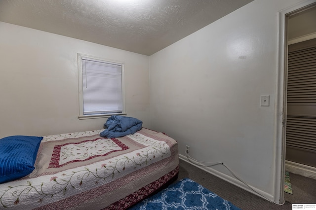 bedroom featuring dark colored carpet