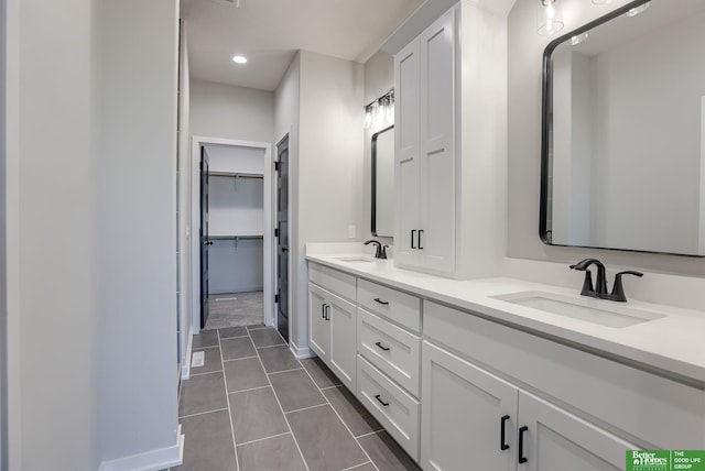 bathroom featuring tile patterned flooring and vanity