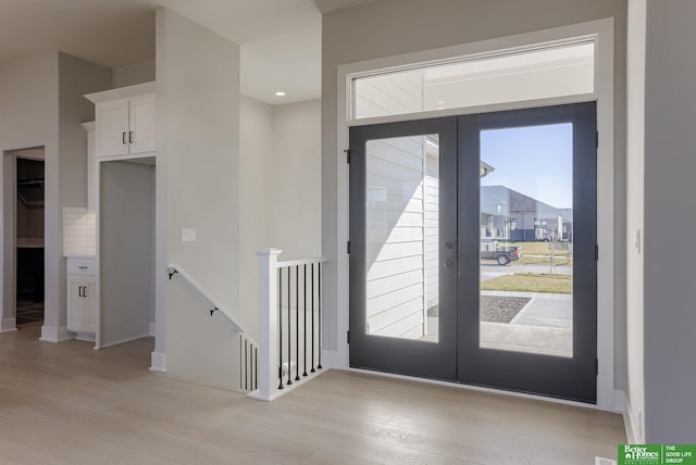 entryway featuring french doors and light wood-type flooring