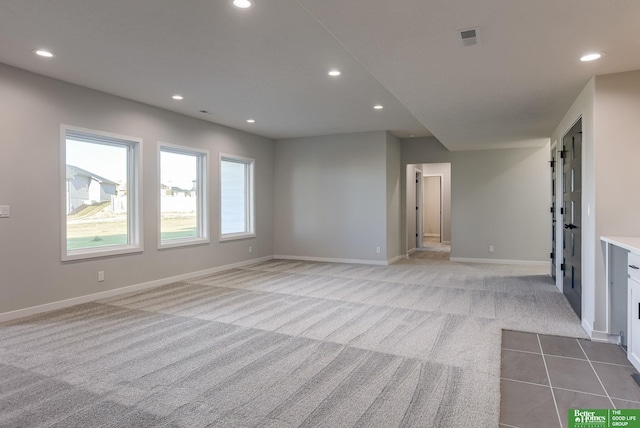 unfurnished living room with light carpet